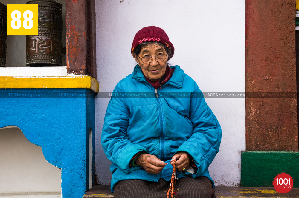 Buddhist woman reciting prayers