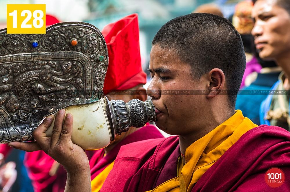 Monk blowing conch shell