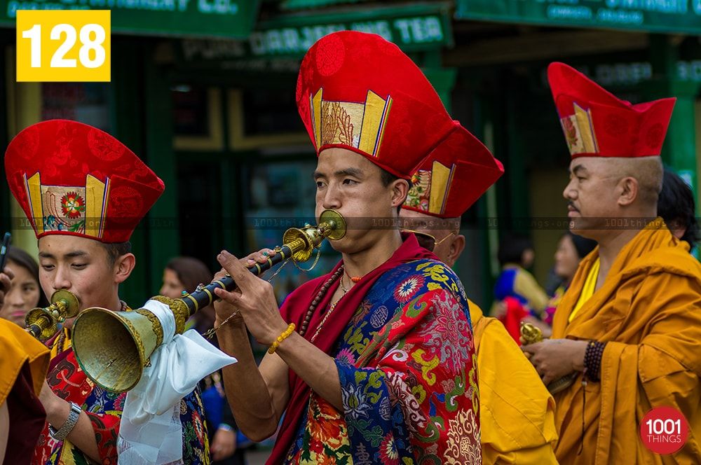 Monk blowing horns